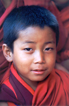 Novice monk photographed on a  tour or trek to Bhutanin Bhutan monastery.  Monk